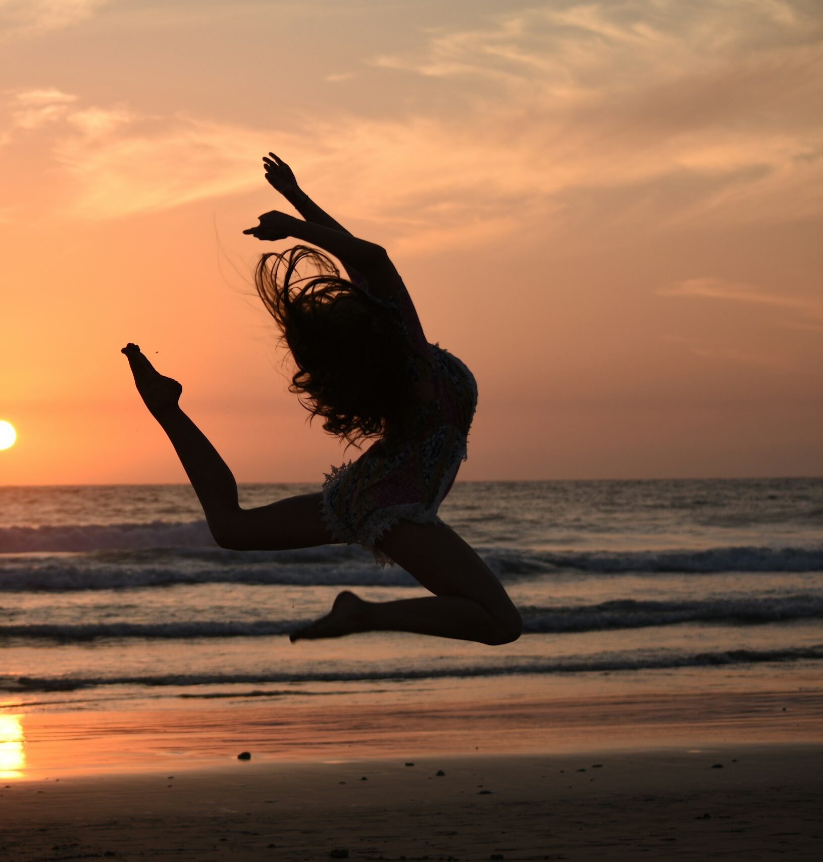 silhouette-of-woman-jumping-during-sunset